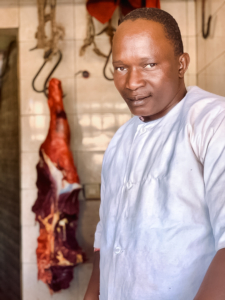 Man standing in front of meat